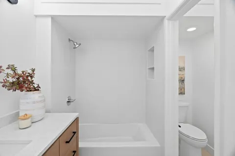 a bathroom with a sink toilet and vanity
