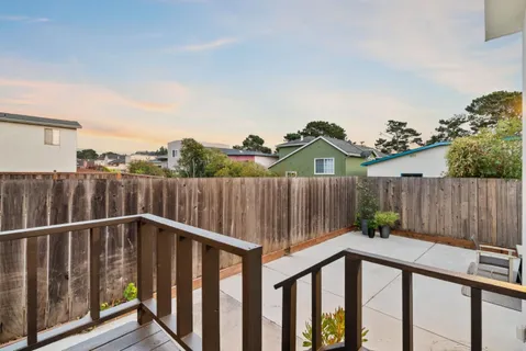 a view of a street with a wooden fence