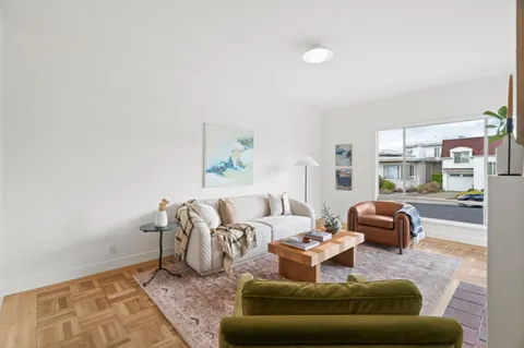 a living room with furniture and a rug