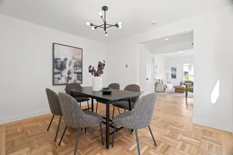 a view of a dining room with furniture and chandelier