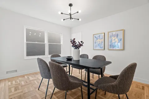 a view of a dining room with furniture and chandelier
