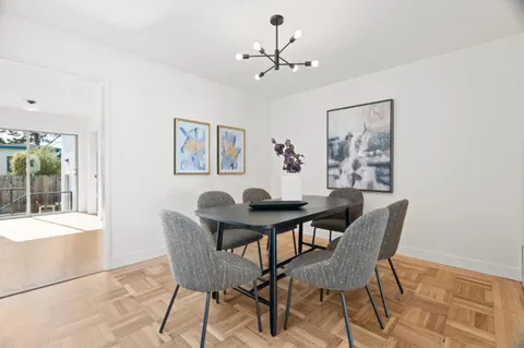 a view of a dining room with furniture and chandelier