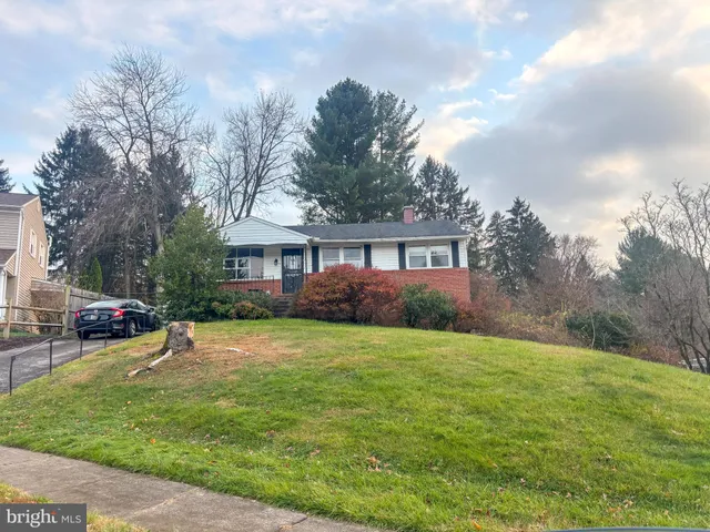 a view of a house with a yard and sitting area