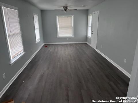 127 Parchman San Antonio, TX 78221 - Photo 2 of 6 a view of an empty room with wooden floor and a window
