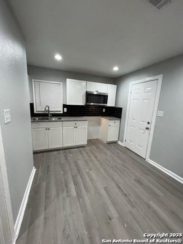 127 Parchman San Antonio, TX 78221 - Photo 3 of 6 a kitchen with refrigerator and cabinets