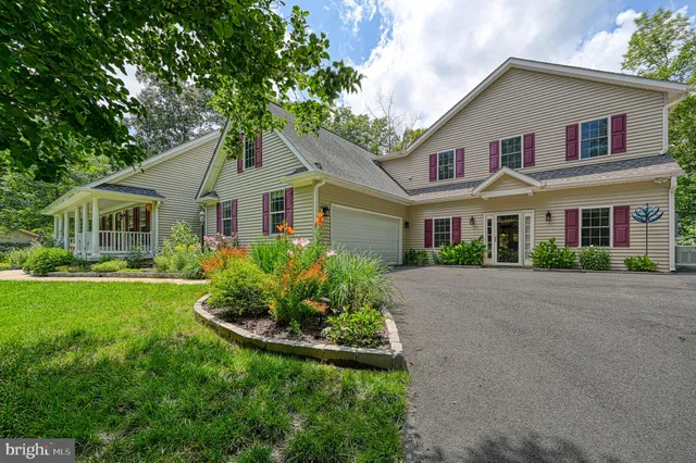 a front view of a house with a yard and porch