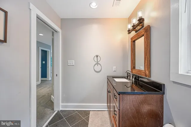 a spacious bathroom with a granite countertop sink mirror and a