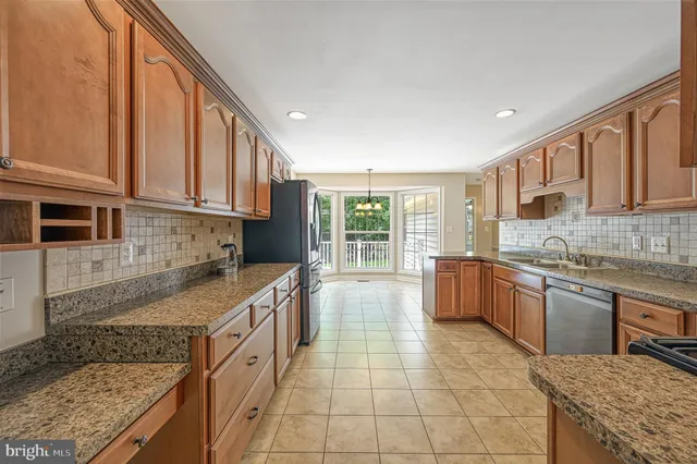 a view of a patio with table and chairs and potted plants