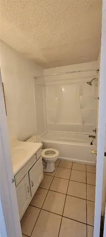 a bathroom with a granite countertop sink a toilet and a shower
