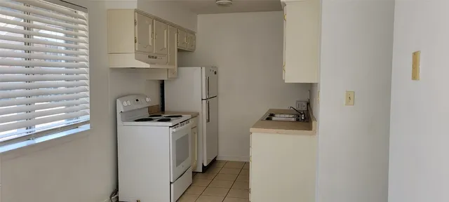 a kitchen with stainless steel appliances granite countertop a stove and a refrigerator