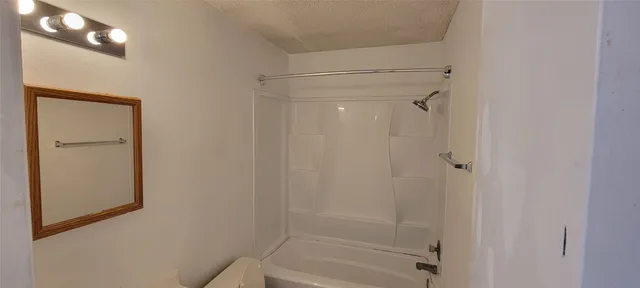a bathroom with a glass shower door