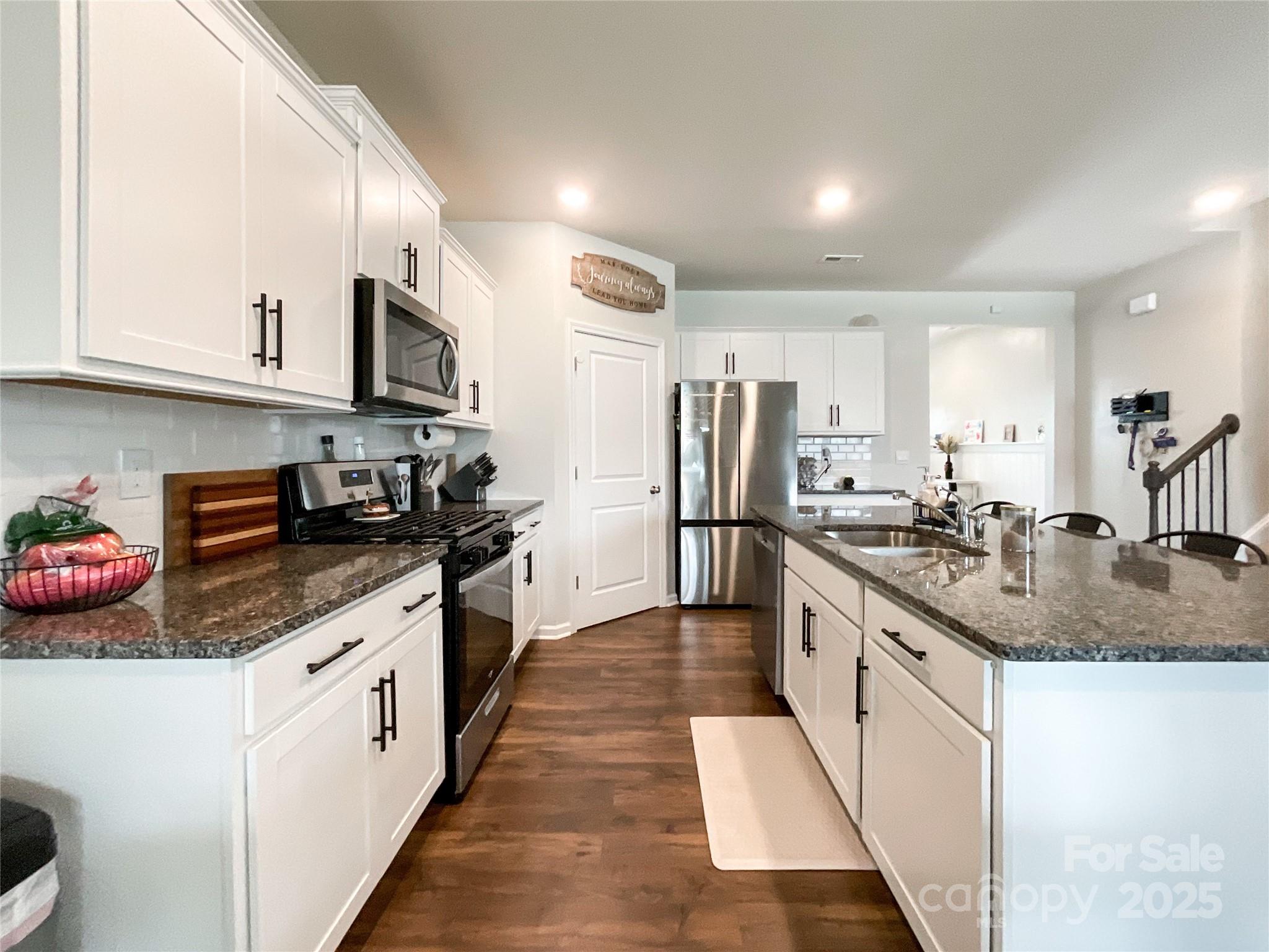 2159 Vanderlyn Street Monroe, NC 28112 - Photo 13 of 44 a large kitchen with stainless steel appliances granite countertop a sink a stove and cabinets