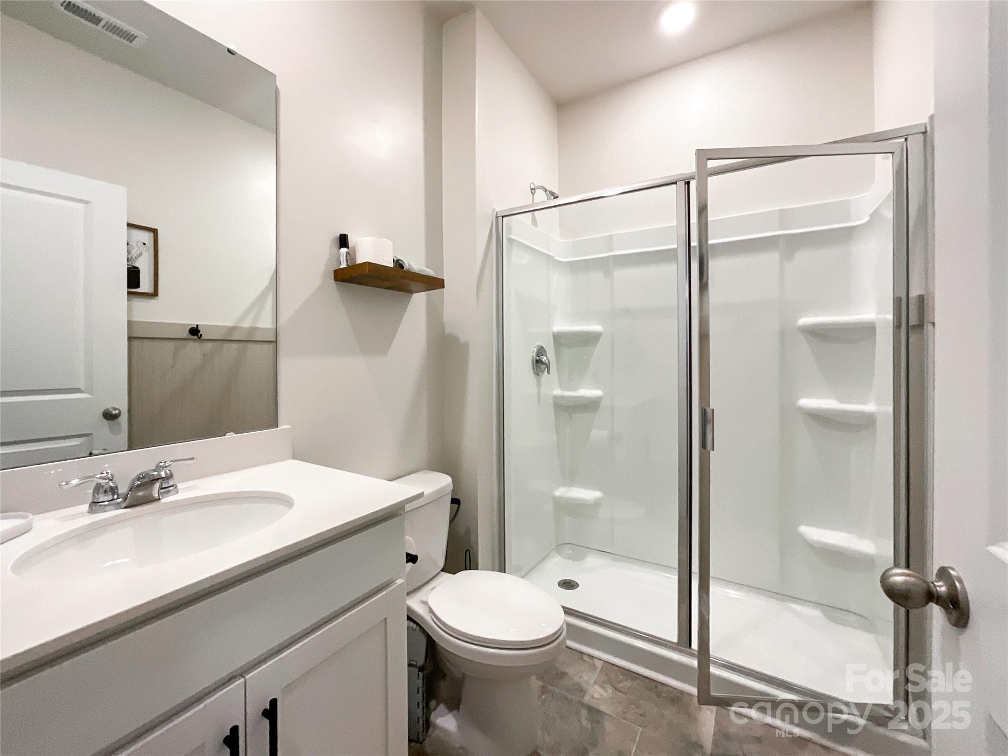 2159 Vanderlyn Street Monroe, NC 28112 - Photo 14 of 44 a bathroom with a shower sink vanity mirror and toilet
