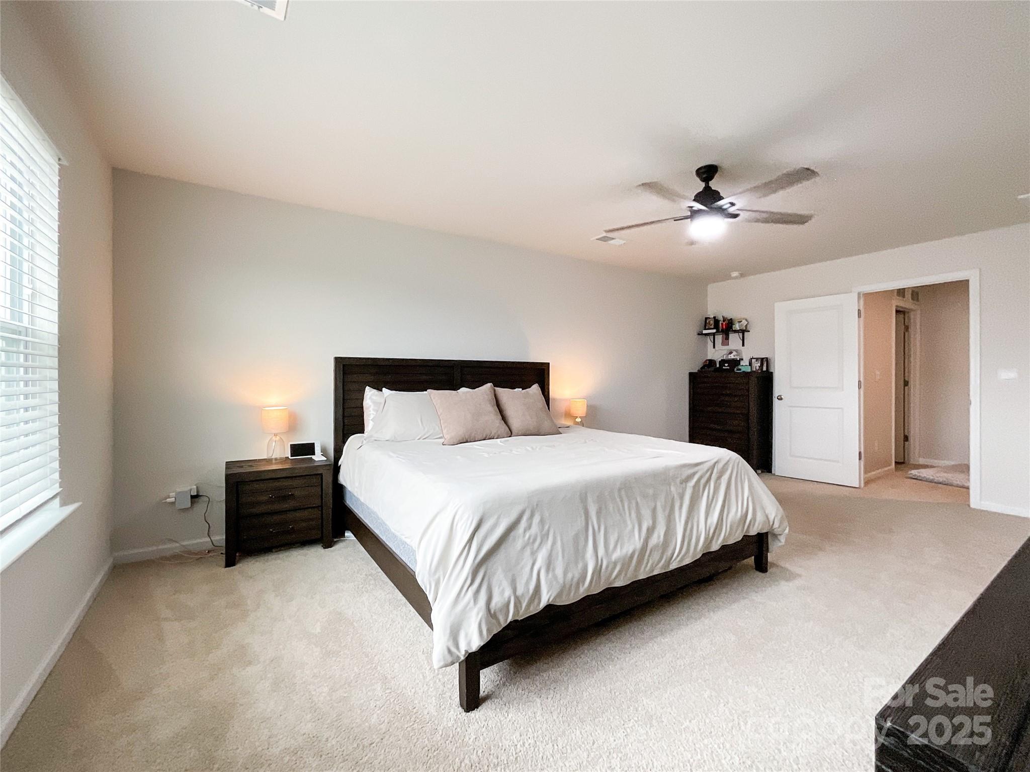 2159 Vanderlyn Street Monroe, NC 28112 - Photo 17 of 44 a bedroom with a bed and a chandelier