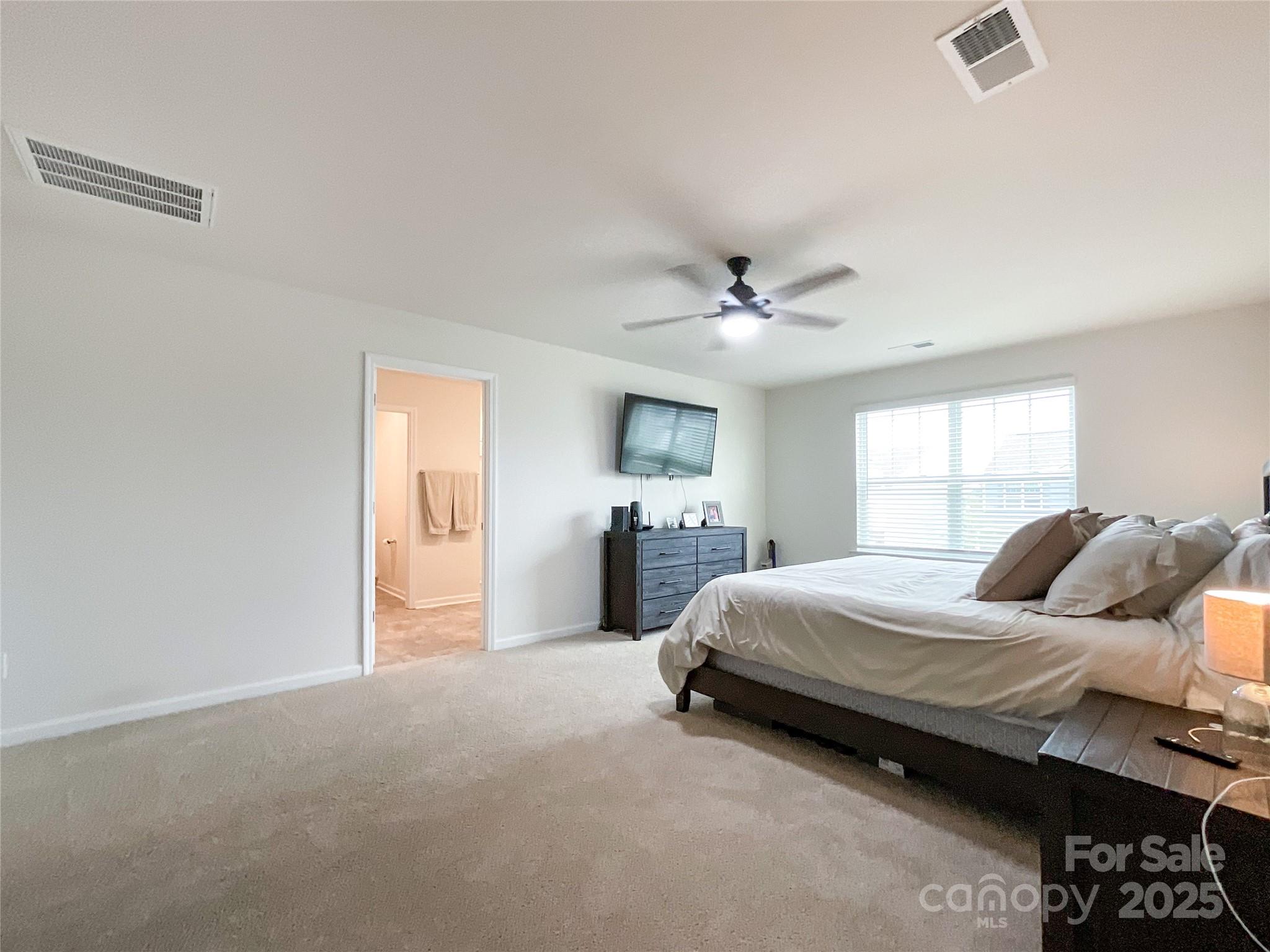 2159 Vanderlyn Street Monroe, NC 28112 - Photo 19 of 44 a bedroom with a bed and ceiling fan