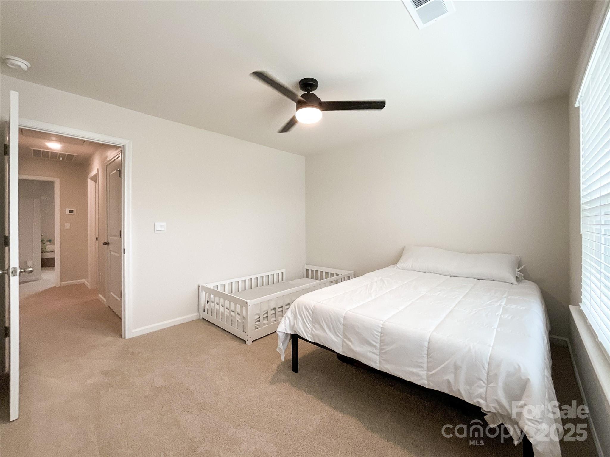 2159 Vanderlyn Street Monroe, NC 28112 - Photo 34 of 44 a bedroom with a bed and a chandelier