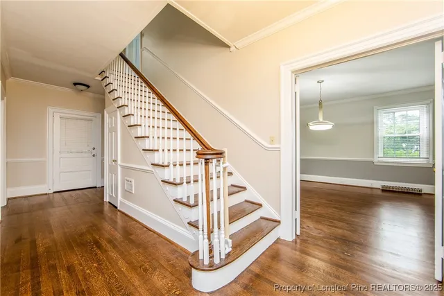 a view of entryway and hall with wooden floor