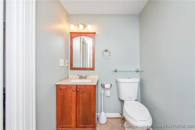 a bathroom with a toilet a sink and mirror