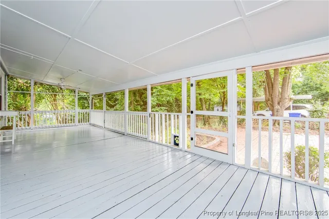 a view of a room with wooden floor and windows