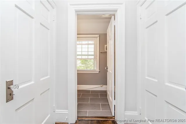 a view of a hallway with wooden floor and entryway