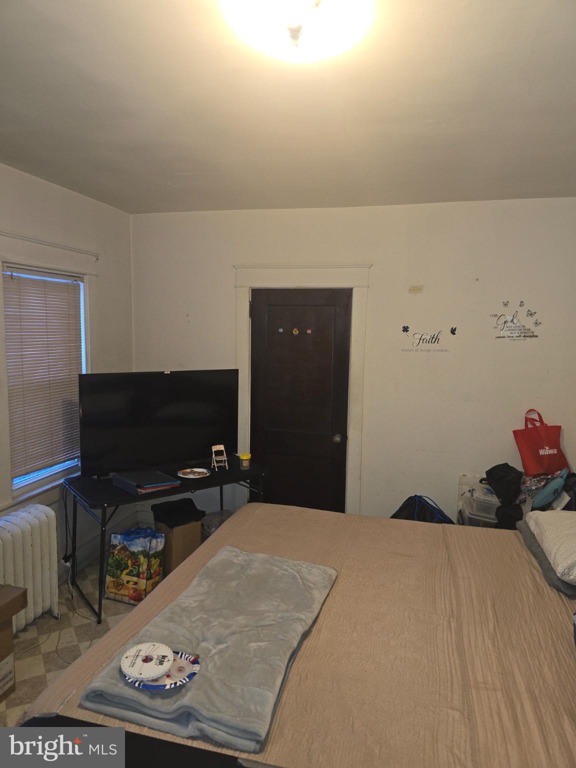 30 East Mowry Street Chester, PA 19013 - Photo 9 of 15 Cozy bedroom with warm, inviting light.