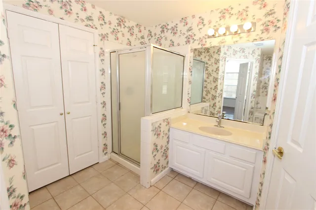 a spacious bathroom with a double vanity sink and a mirror