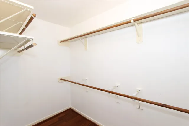 a view of small space with racks on the wall and a window