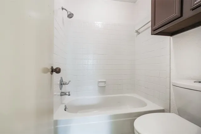 a bathroom with a bathtub and a toilet