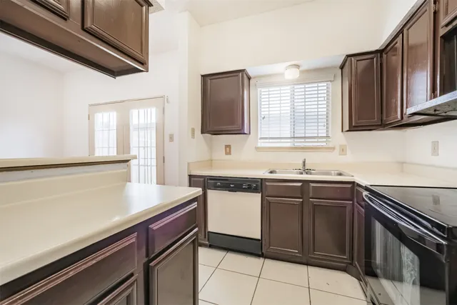 a kitchen with a sink stove and cabinets