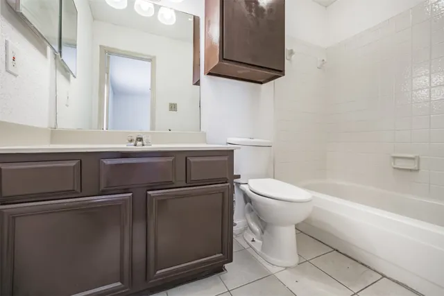a bathroom with a sink a toilet and bathtub