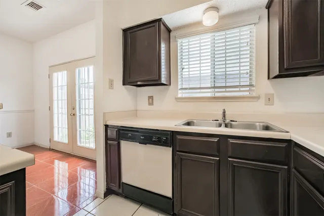 a kitchen with a sink stove and cabinets