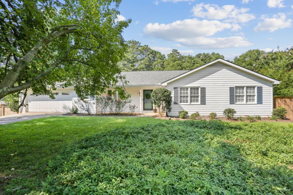 380 Chaffin Road Roswell, GA 30075 - Photo 1 of 1 a front view of a house with a garden