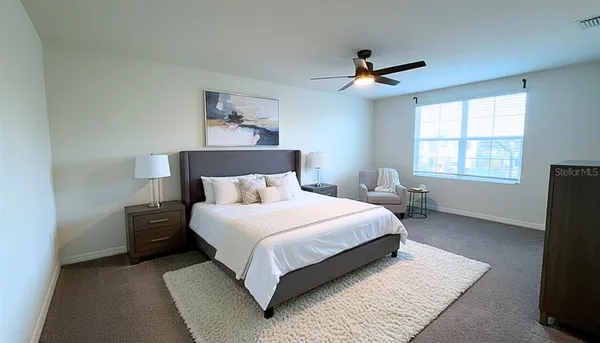 a bedroom with a bed and window