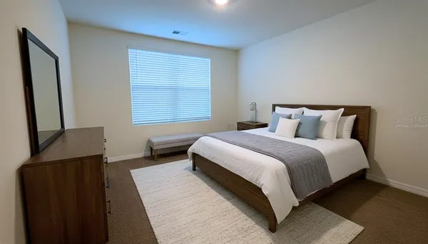 a bedroom with a bed and a window