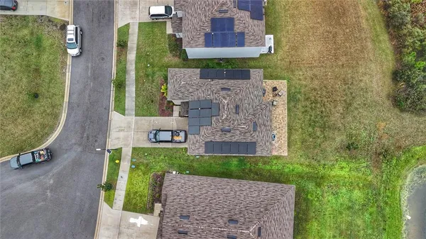 an aerial view of a house with a garden and plants