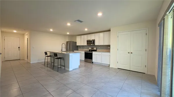 a kitchen with a cabinets and chairs in it