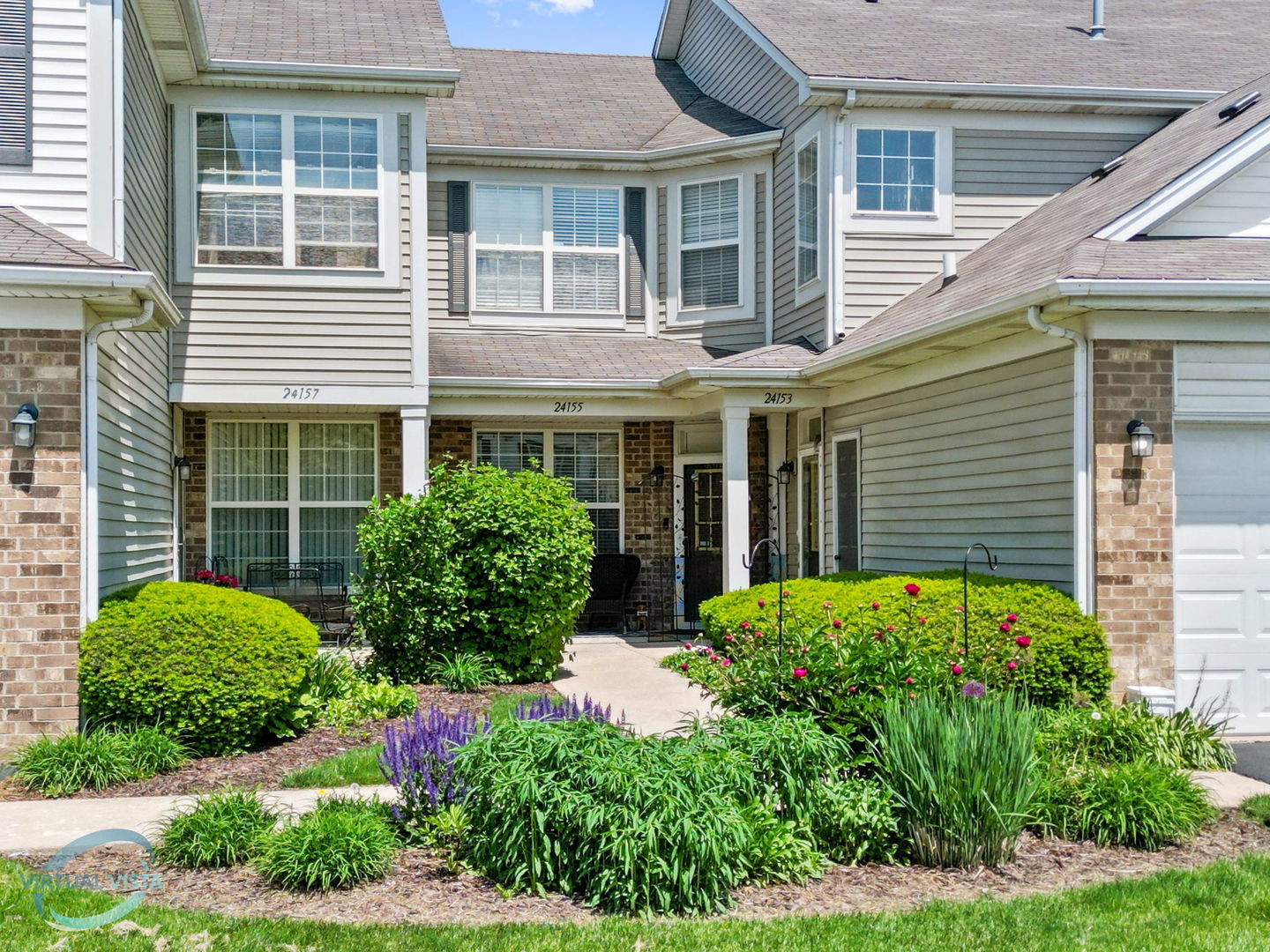 a view of a house with potted plants