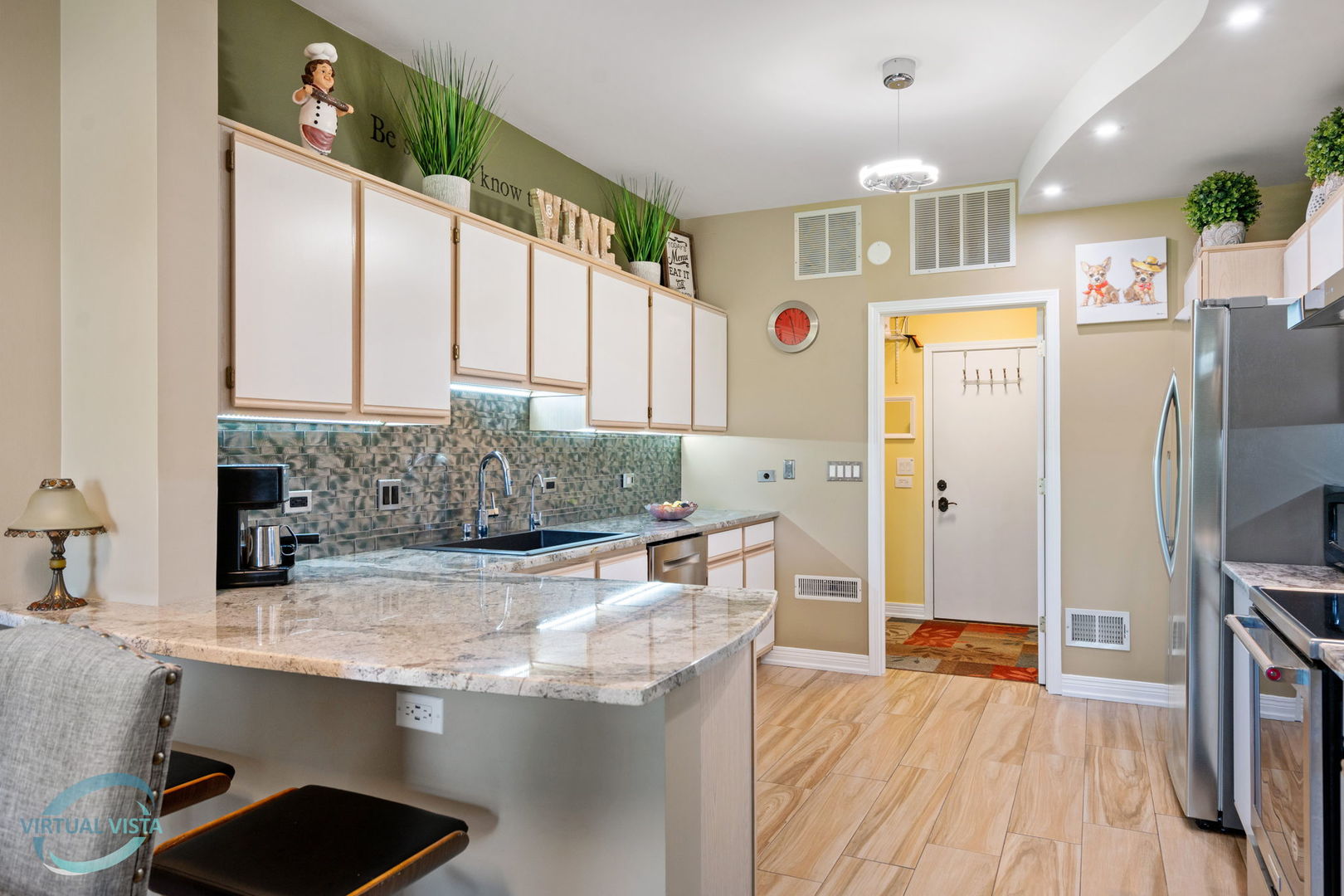 24155 Pear Tree Circle Plainfield, IL 60585 - Photo 11 of 27 a kitchen with stainless steel appliances granite countertop a sink stove and refrigerator