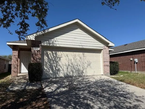 a front view of house with a garden