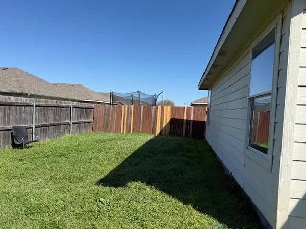 a view of backyard of house with green space