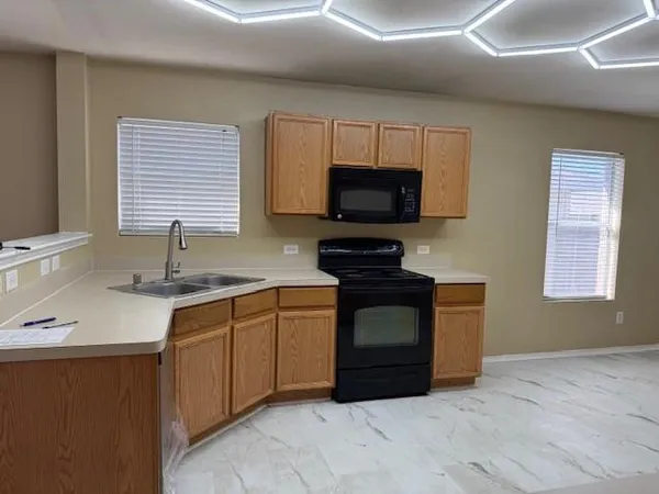 a kitchen with stainless steel appliances granite countertop a sink and a stove