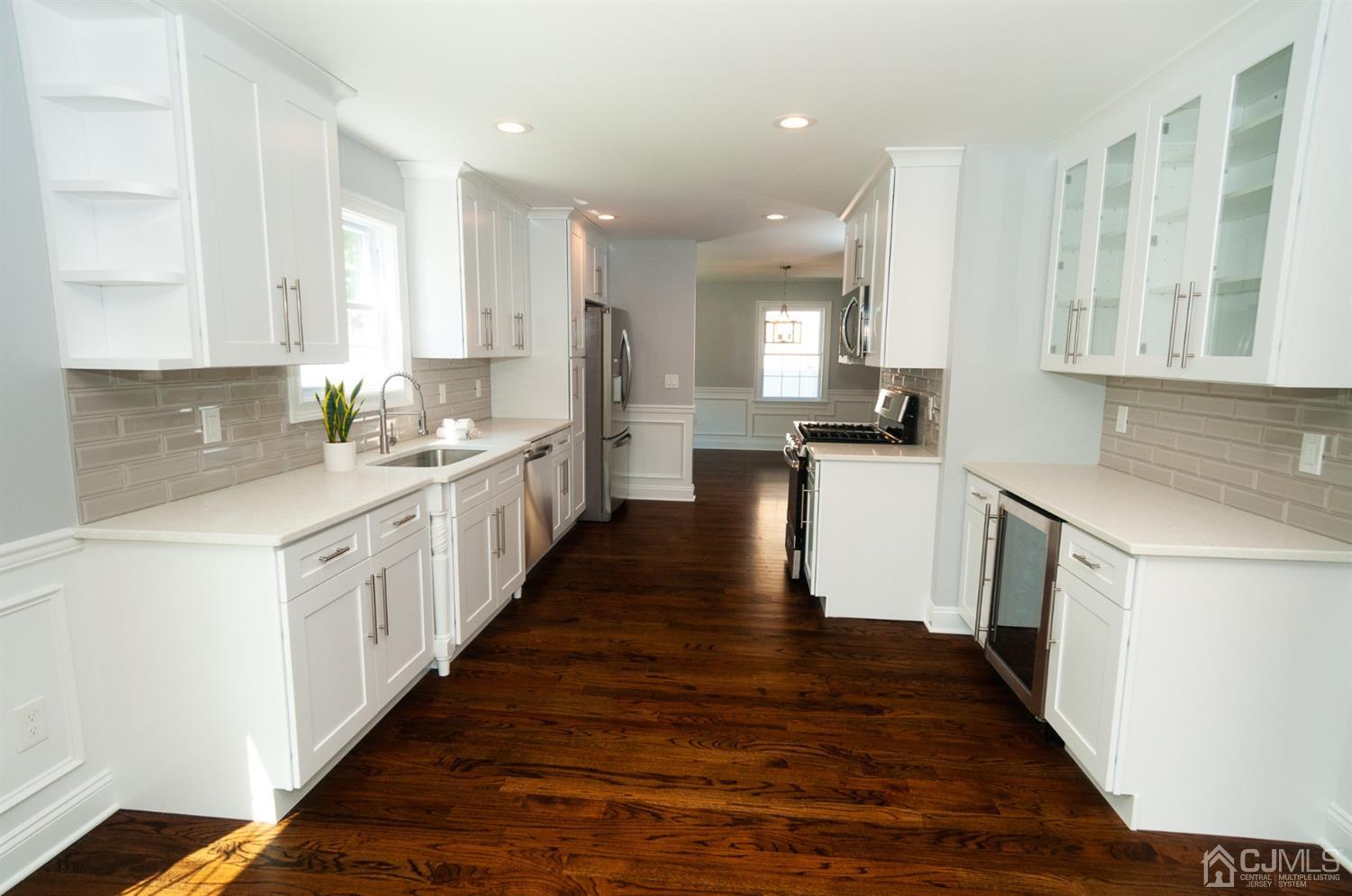 21 Stockton Road New Brunswick, NJ 08901 - Photo 3 of 45 a large kitchen with a lot of counter space and wooden floor