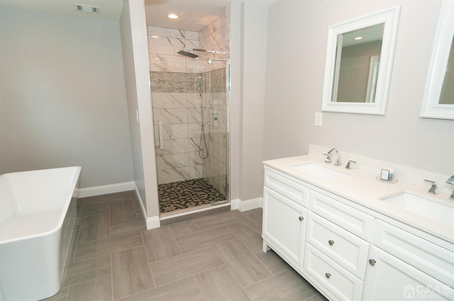 21 Stockton Road New Brunswick, NJ 08901 - Photo 30 of 45 a bathroom with a double vanity sink a shower and a bathtub