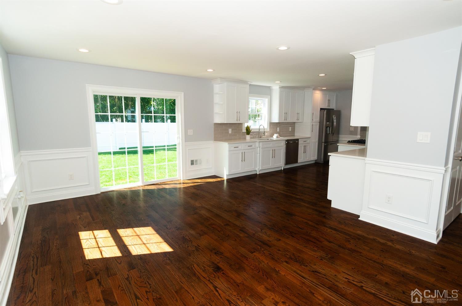 21 Stockton Road New Brunswick, NJ 08901 - Photo 4 of 45 a view of empty room with wooden floor and windows