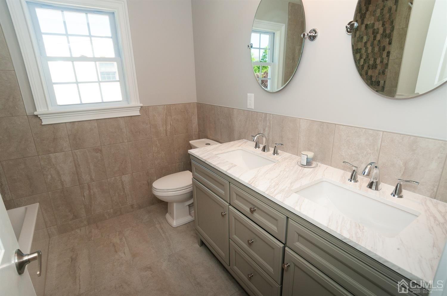 21 Stockton Road New Brunswick, NJ 08901 - Photo 36 of 45 a bathroom with a double vanity sink and a mirror