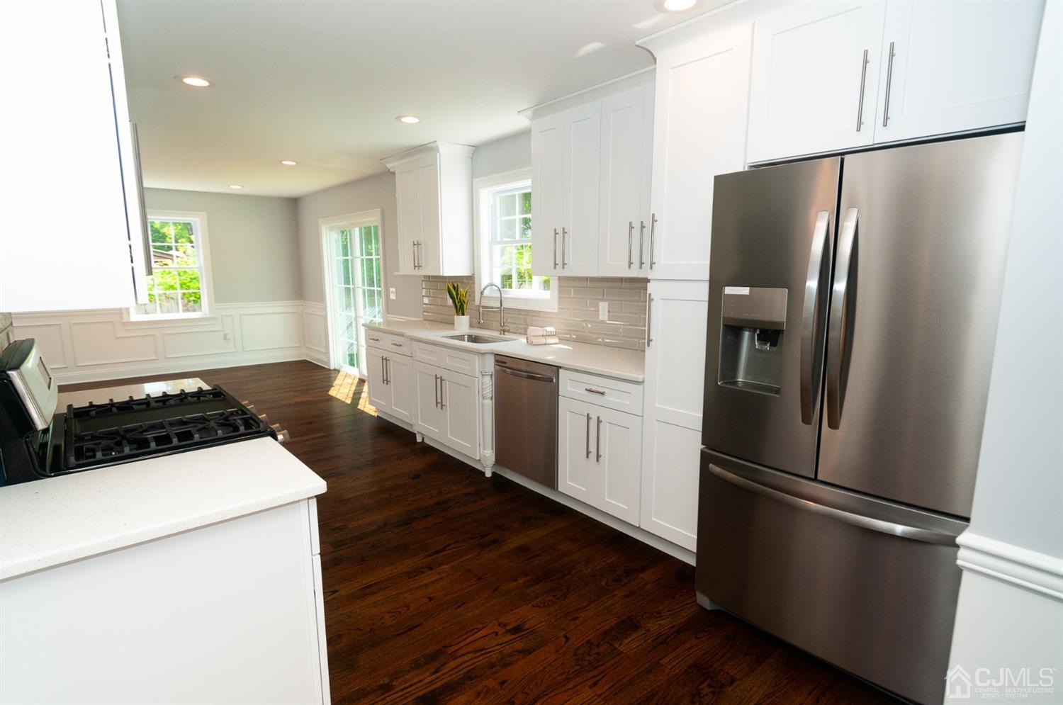 21 Stockton Road New Brunswick, NJ 08901 - Photo 7 of 45 a kitchen with stainless steel appliances a refrigerator a sink and a stove