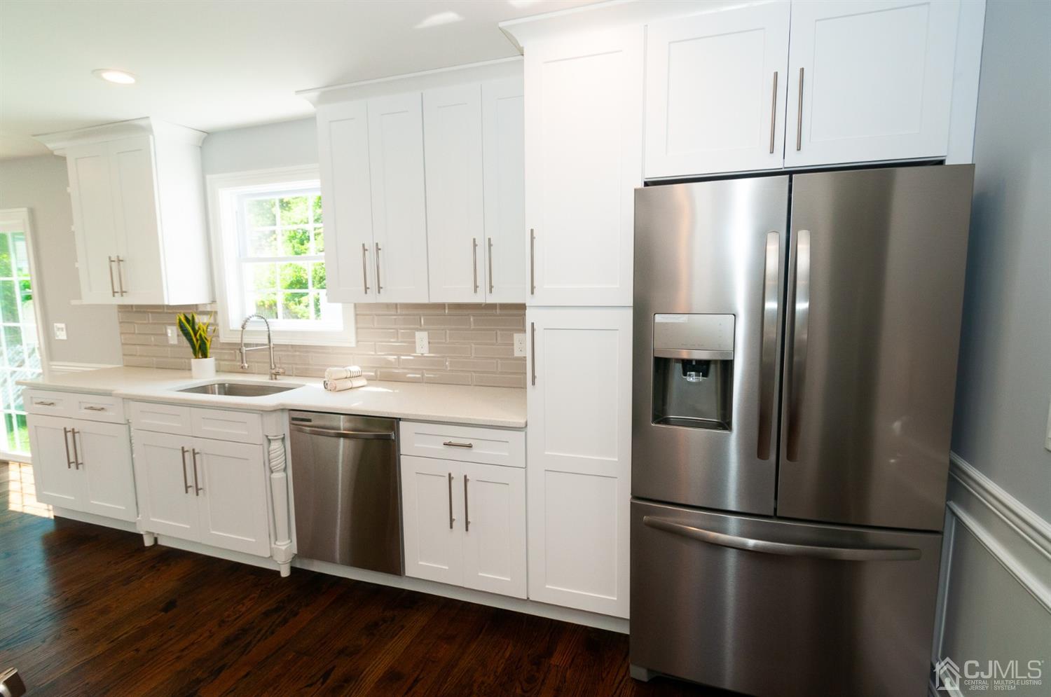 21 Stockton Road New Brunswick, NJ 08901 - Photo 8 of 45 a kitchen with stainless steel appliances granite countertop a refrigerator a sink and white cabinets