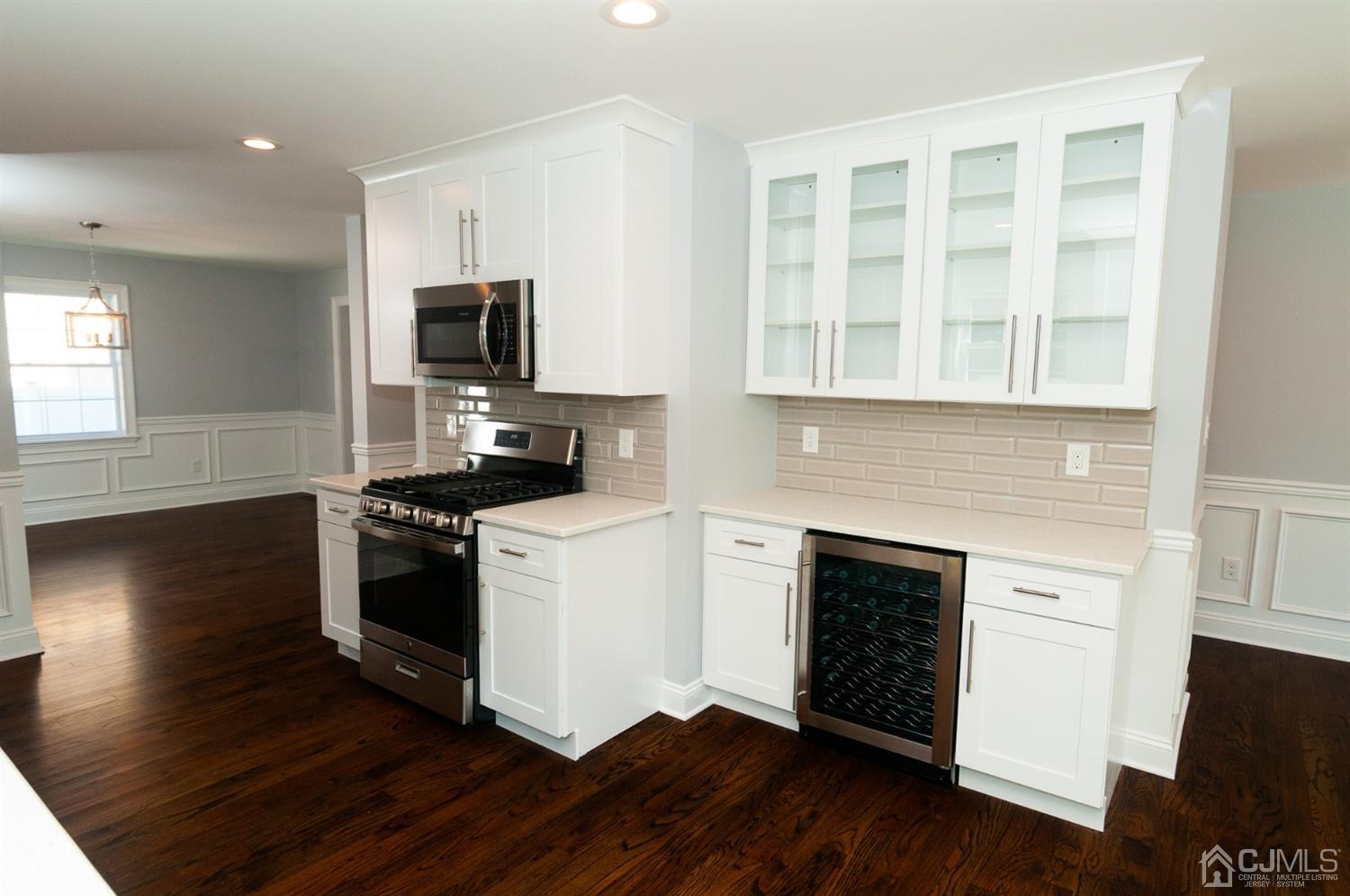 21 Stockton Road New Brunswick, NJ 08901 - Photo 9 of 45 a kitchen with stainless steel appliances a stove top oven a sink and a granite counter tops with wooden floors