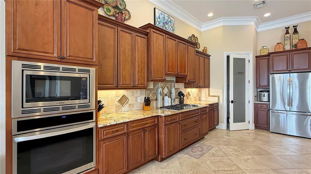 451 Muirfield Loop Reunion, FL 34747 - Photo 19 of 67 a kitchen with a refrigerator stove and sink