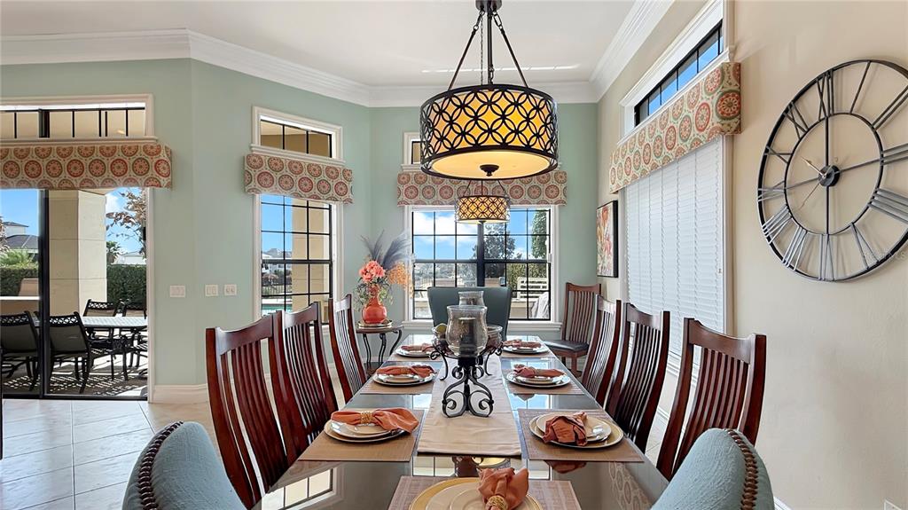 451 Muirfield Loop Reunion, FL 34747 - Photo 22 of 67 a view of a dining room with furniture chandelier and wooden floor